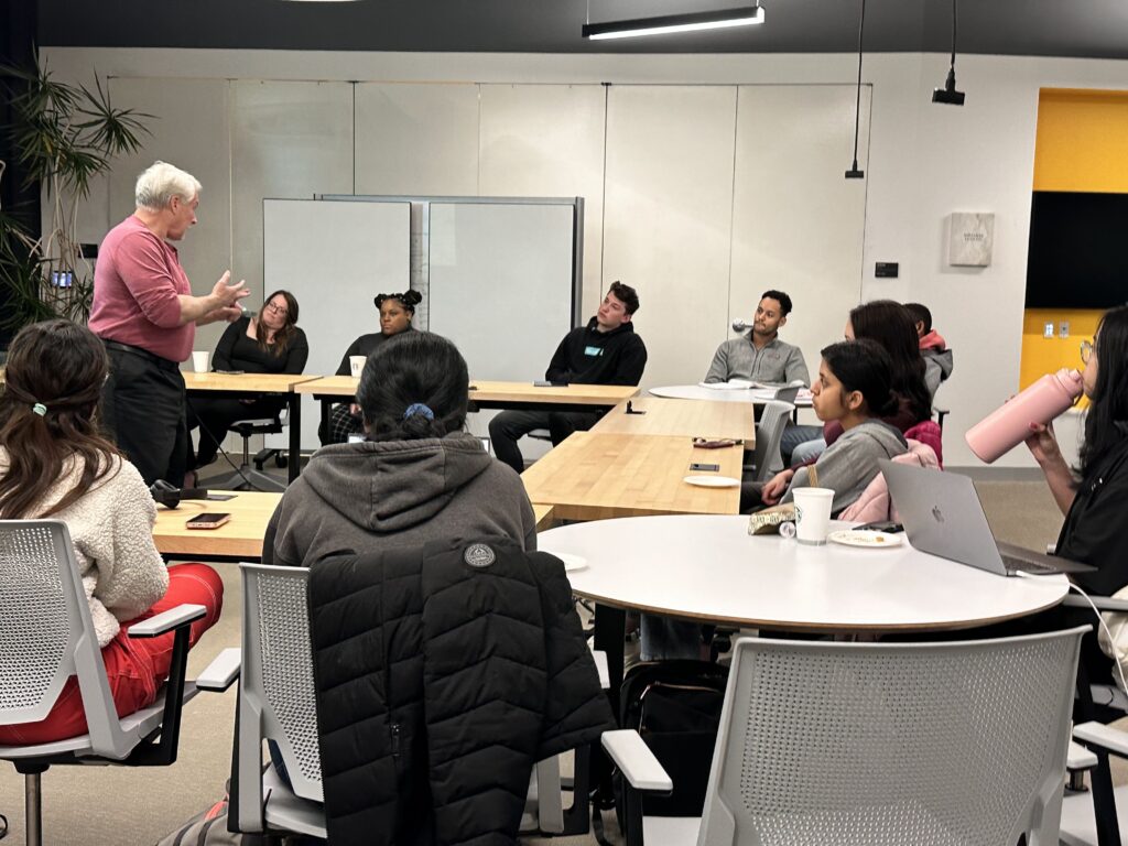Marty Johnson speaking with a group of students on the topic of leadership. 